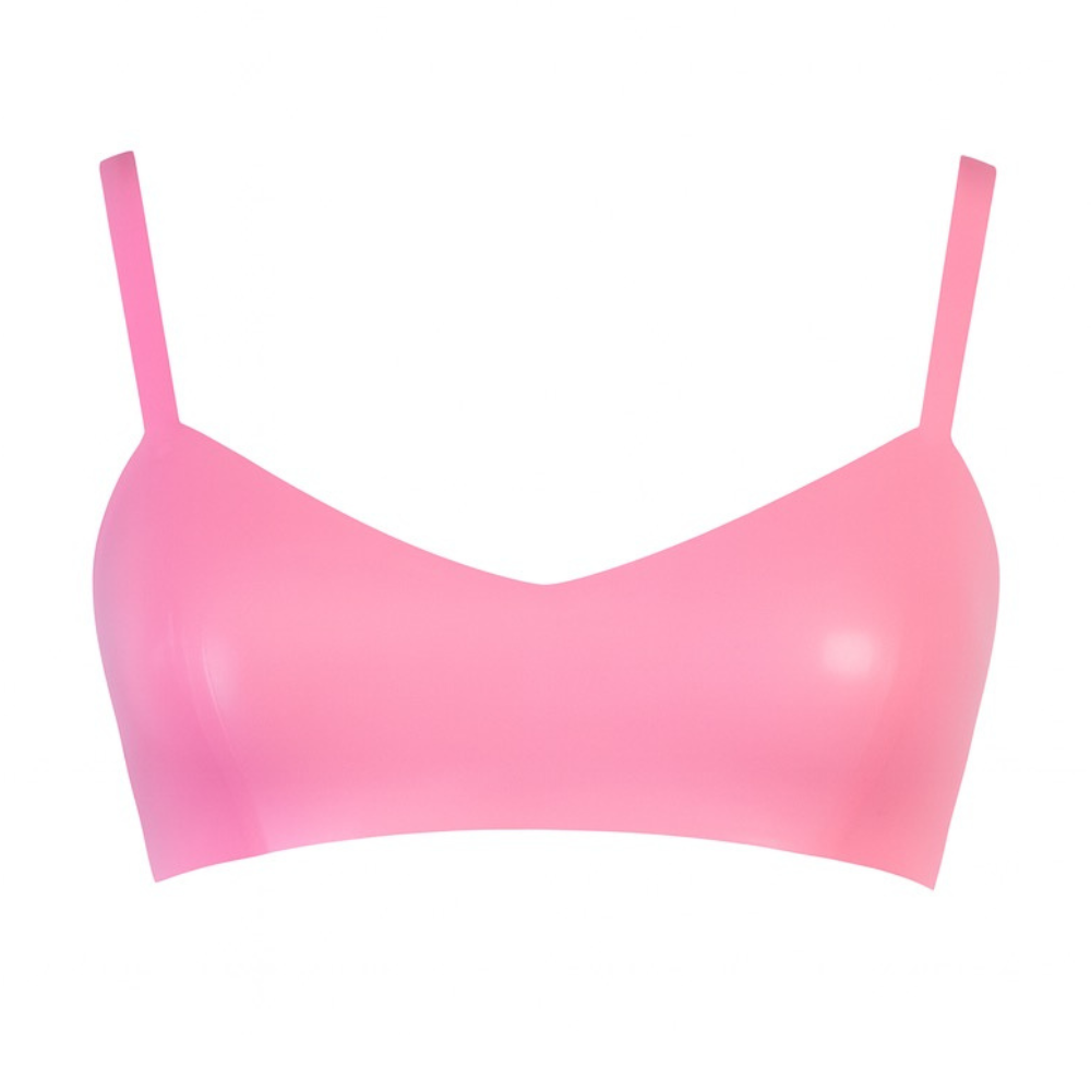 A seamless, light pink bra top by Vex Clothing, INC features thin, adjustable straps and is displayed on a white background.