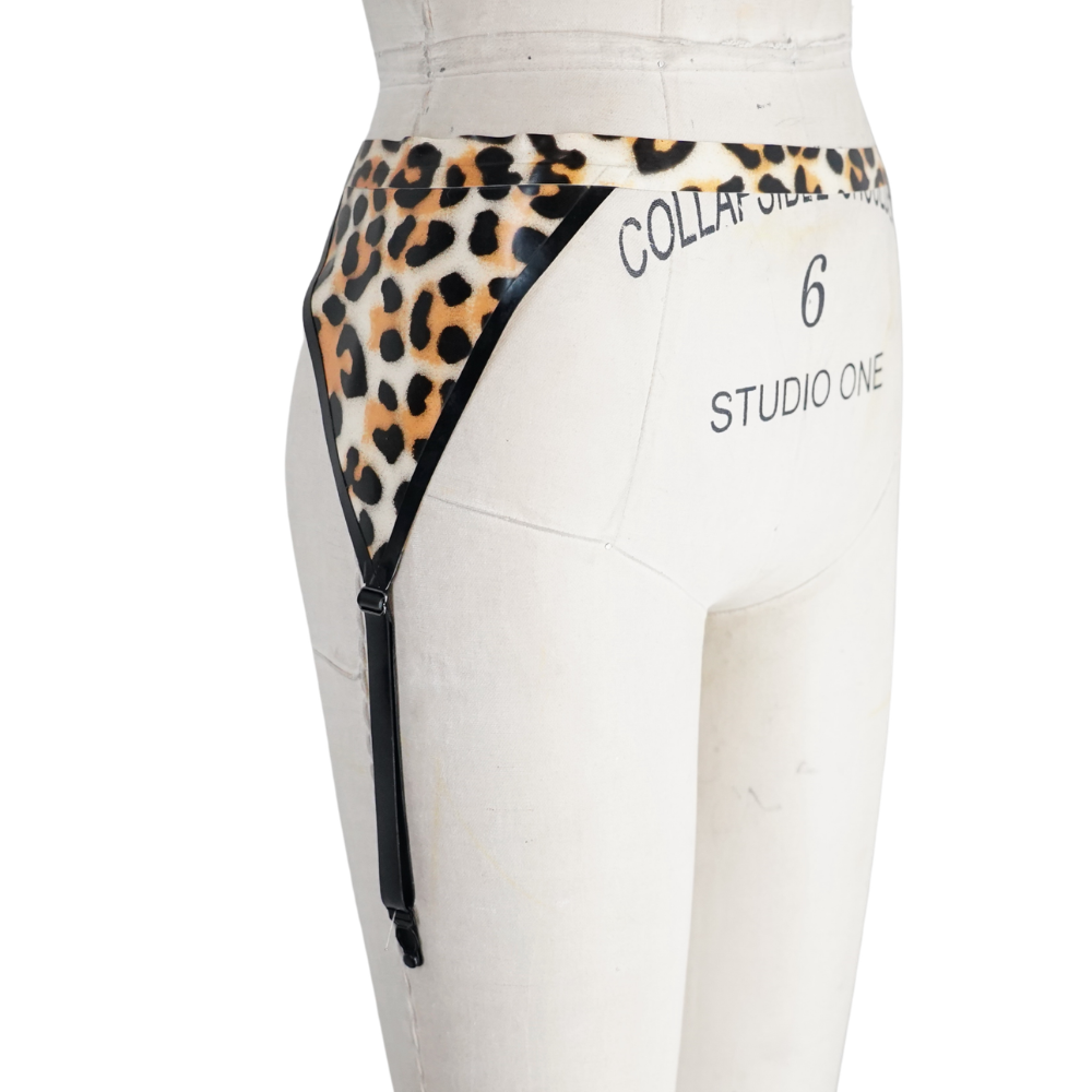 A dress form marked COLLAR SIZE 6 STUDIO ONE displays a Vex Clothing, INC leopard print garter belt with black trim, an adjustable side strap, and a "Ready to Ship" banner—an ideal accent for your collection.