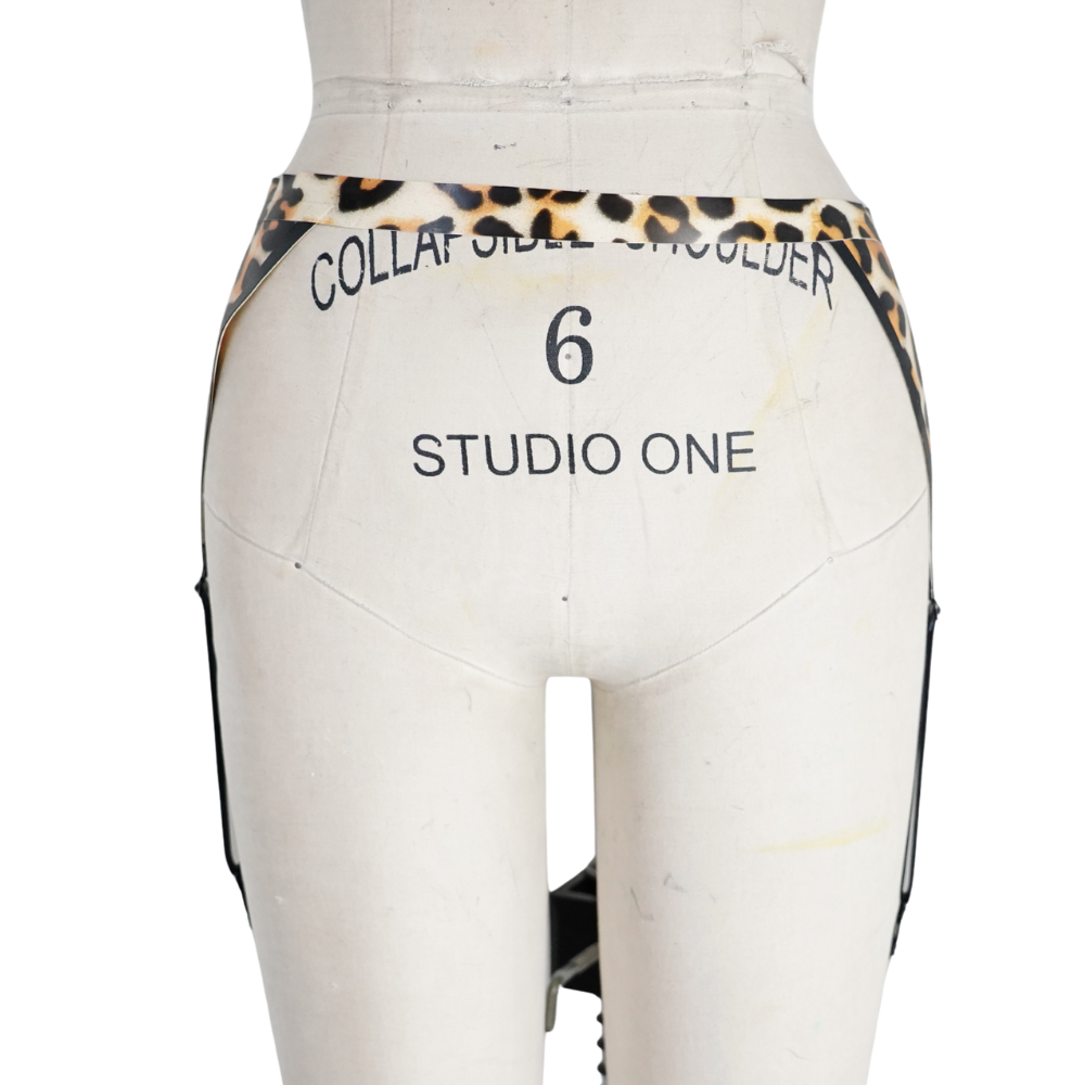 A Vex Clothing, INC dress form mannequin with COLLAR SHELL SHOULDER 6 and STUDIO ONE on the back, dressed in a leopard print waistband and black strappy garment—ideal for displays or your Accent Bar. Ready to Ship.