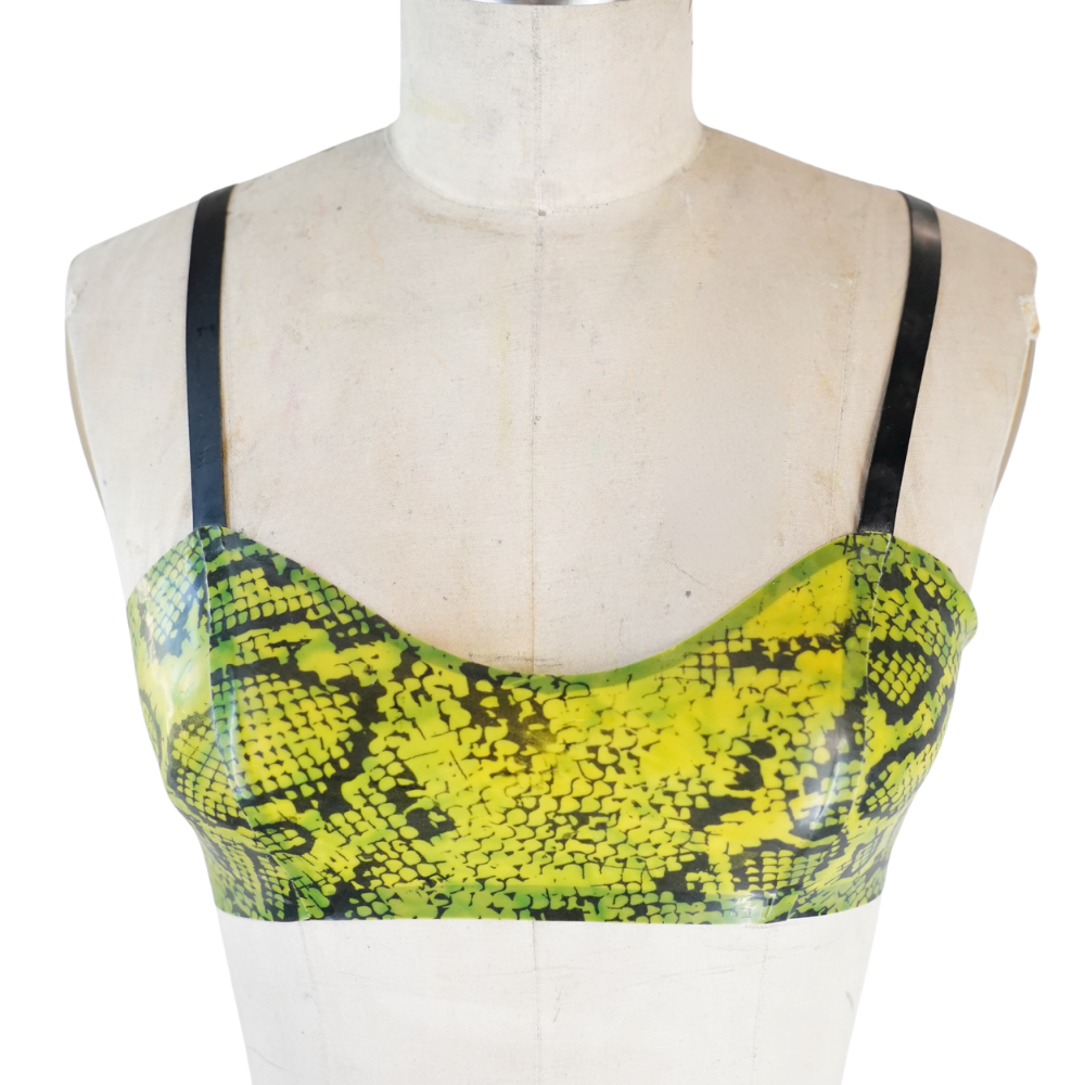 A mannequin torso displays a yellow and green snakeskin-patterned crop top with thin black straps by Vex Clothing, INC—perfect for adding a bold accent to your outfit. Ready to ship.