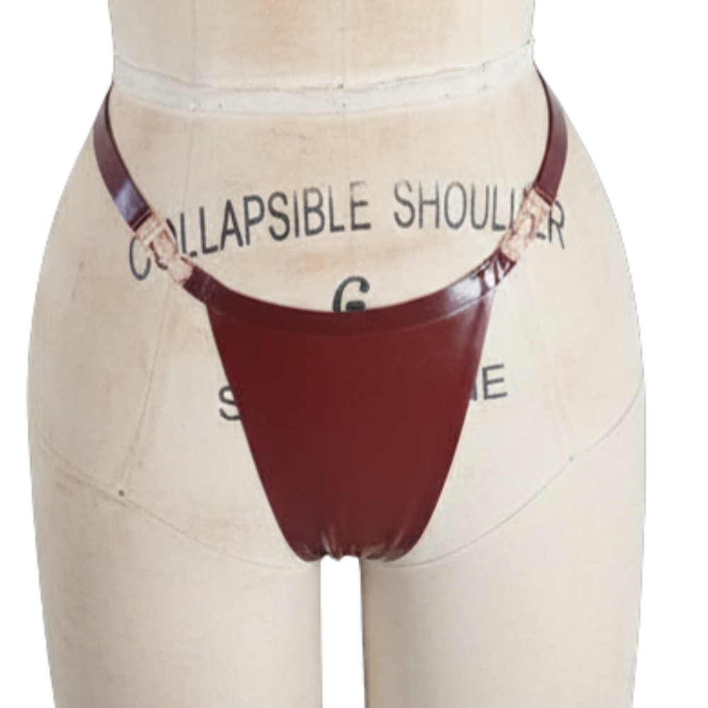 A dress form mannequin displays a dark brown leather thong-style garment with side straps and metal rings at the hips by Vex Latex. "Ready to Ship" is shown on a banner, and the mannequin features size and tailoring markings.