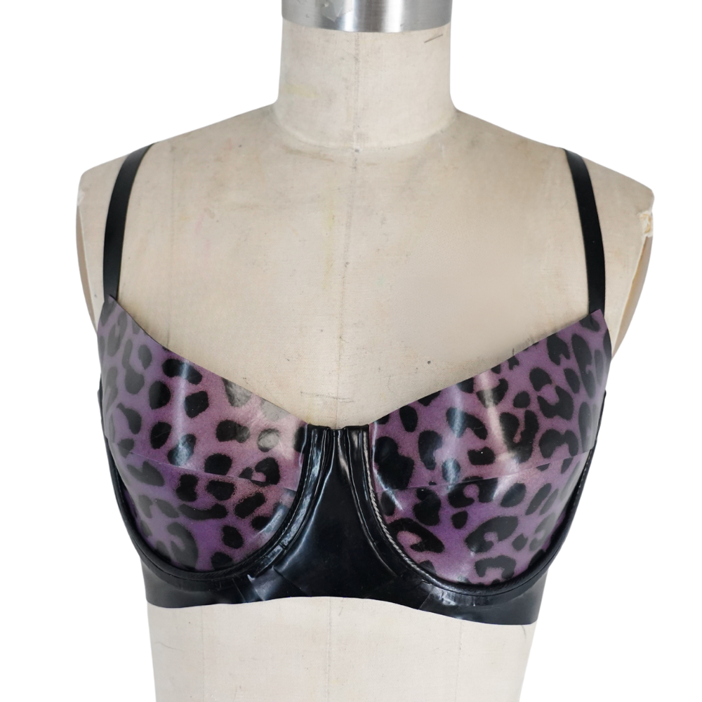 A mannequin models a shiny, purple leopard-print bra with black trim by Vex Inc. | Latex Clothing—ready to ship and perfect for your next banner or Accent Bar decor.