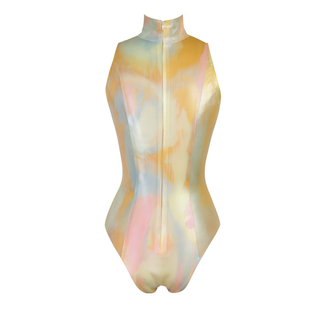 The Vex Inc. Latex Clothing sleeveless mock turtleneck bodysuit features a glossy pastel watercolor pattern in yellow, blue, and pink, front zipper closure, and is handmade in California.