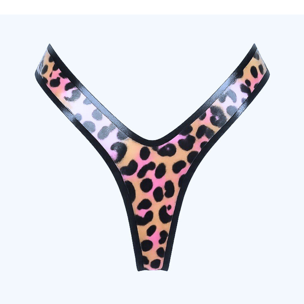 The Vex Latex handmade thong features a pink and brown leopard print with black trim, an extreme high cut design, and is showcased against a plain light background.