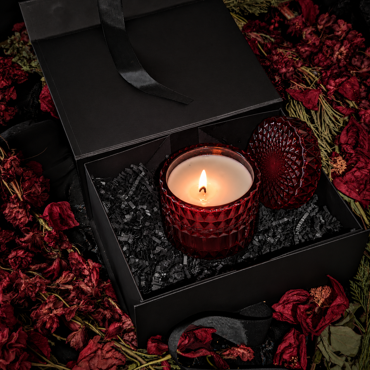 Ritual Candle Gift Set: lit oxblood faceted glass candle in an open black Vex gift box with dried red flowers