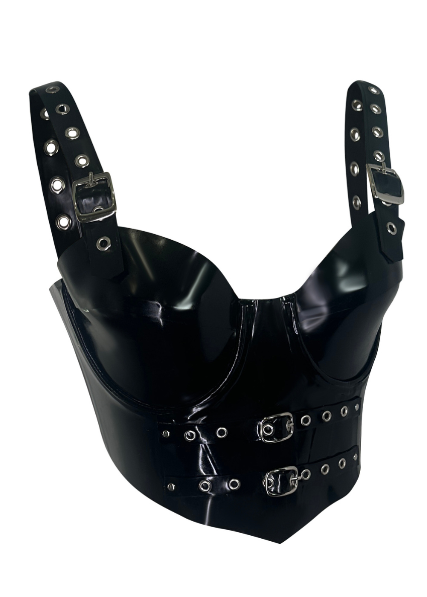 A shiny black latex bustier with silver buckles and grommets on the straps and front, featuring structured cups and decorative hardware.