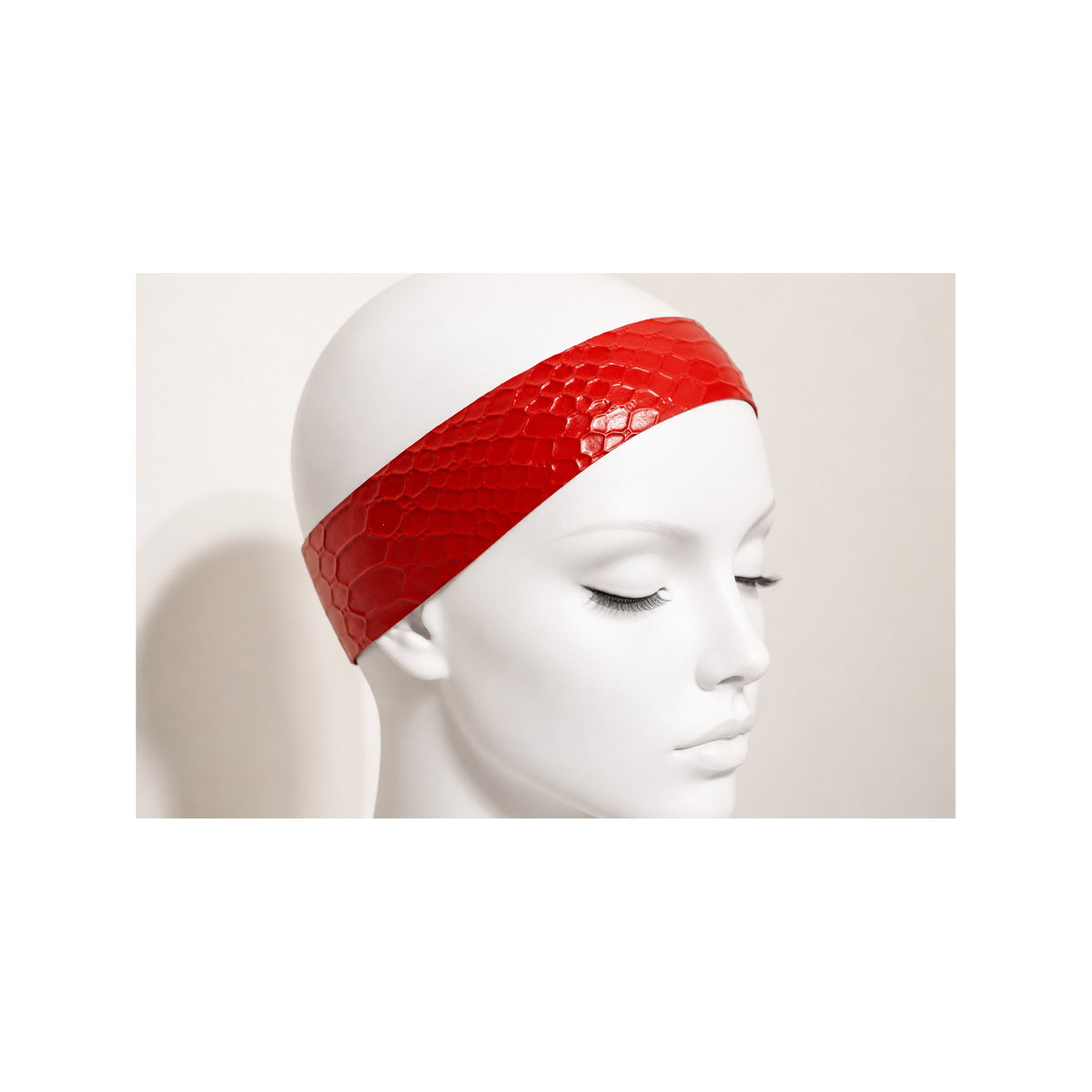 Close view of the Mahogany Snake latex headband worn across the hairline, showing the snake emboss and high-gloss finish — Vex Clothing